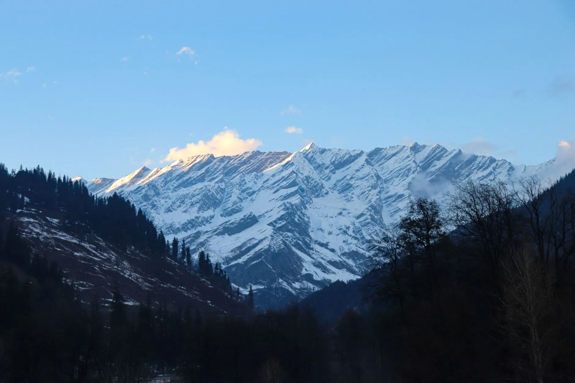Breathtaking view of snowcapped mountains in Manali, Himachal Pradesh, India during winter with clear blue skies.