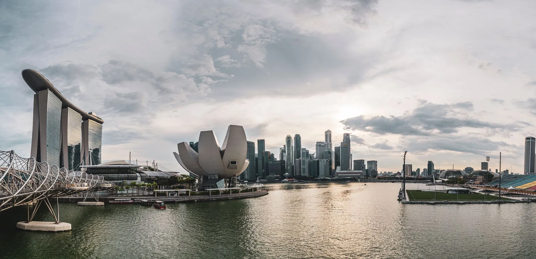 Panoramic view of Singapore skyline featuring modern architecture along the waterfront.