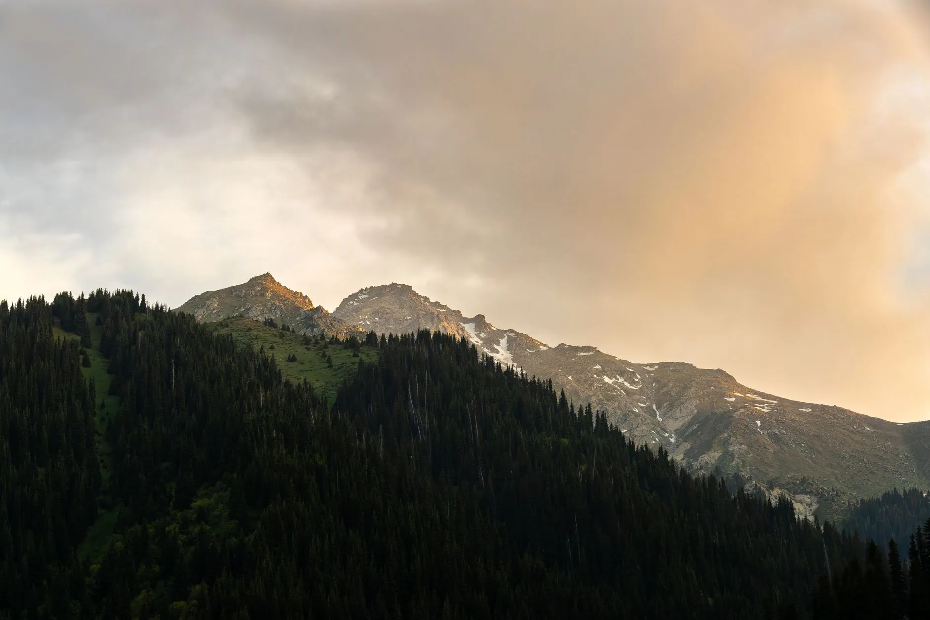 Captivating sunrise over snow-capped mountains in Almaty, showcasing nature's beauty.
