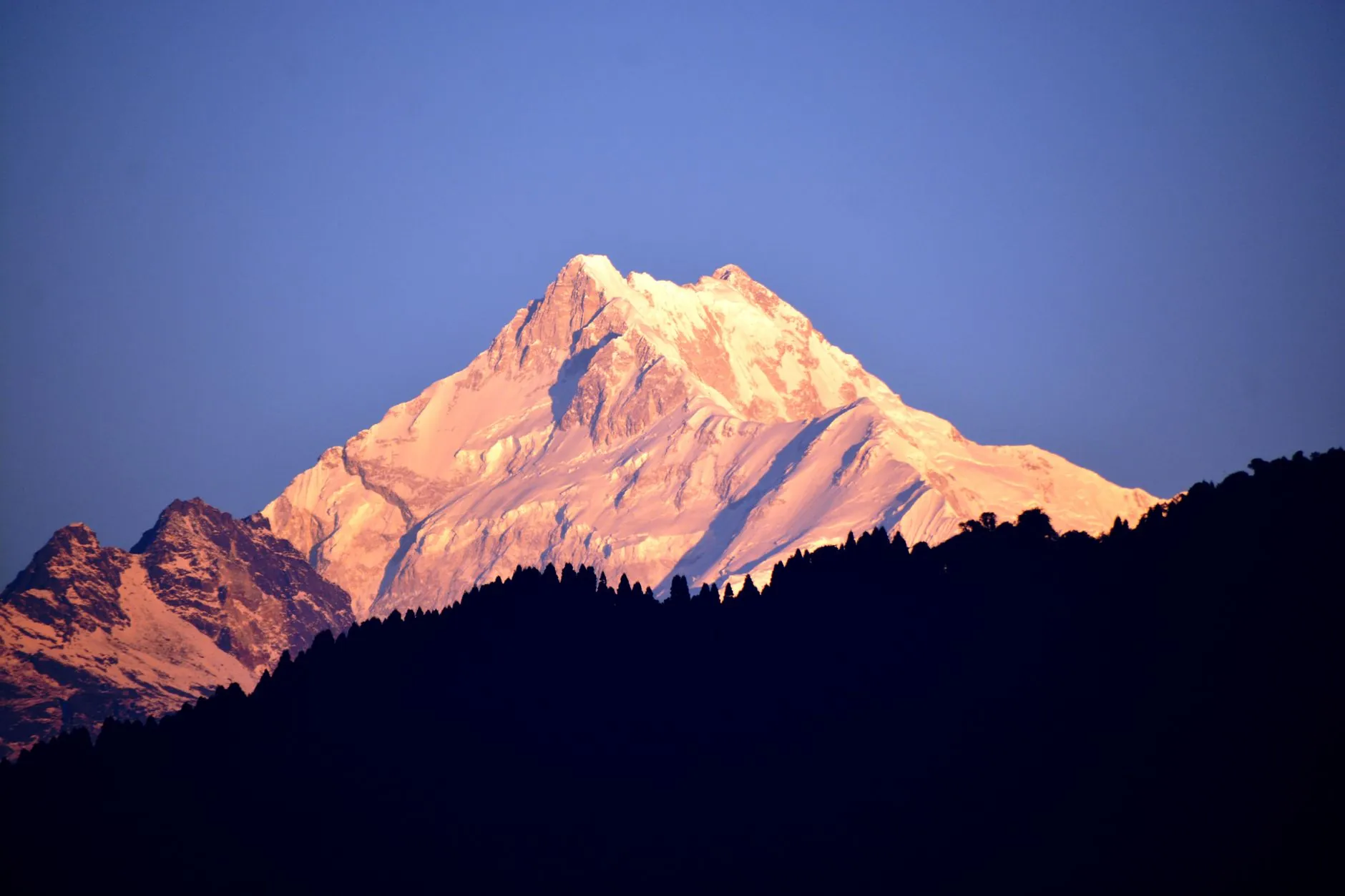 Golden sunrise over Kanchenjunga peak in the Himalayan mountain range of Sikkim, India.