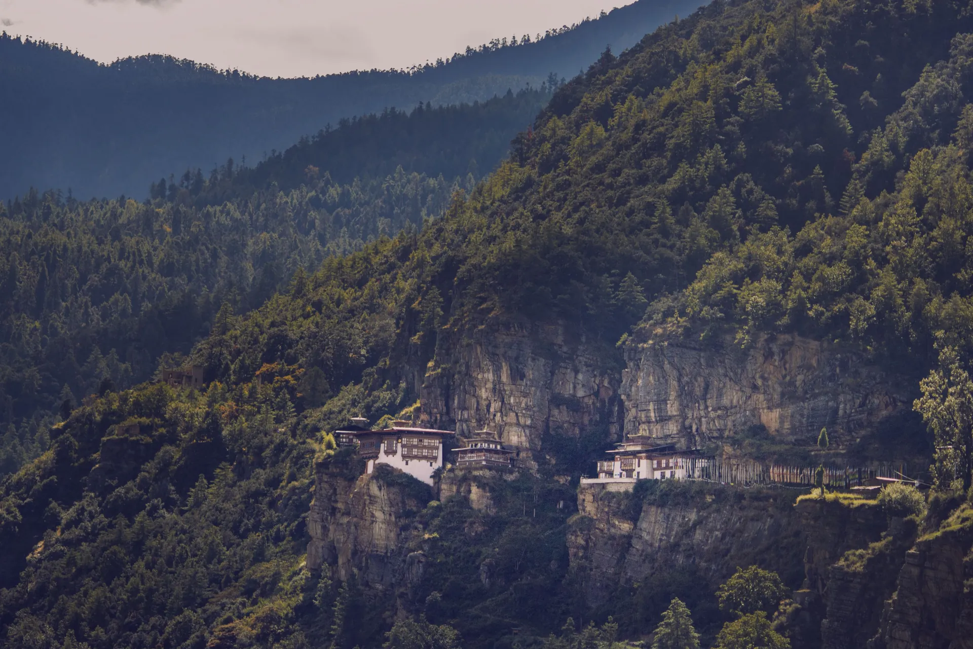 The famous Tiger's Nest Monastery perched on a cliffside in Bhutan's lush mountains.